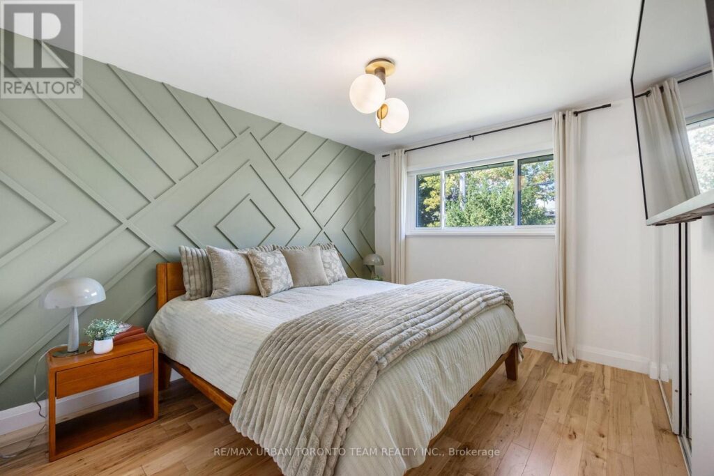 Primary bedroom staged with green accent wall and matching bedding set.