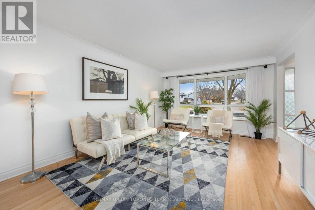 Chrome and white leather living room styled to highlight bay windows and natural light.