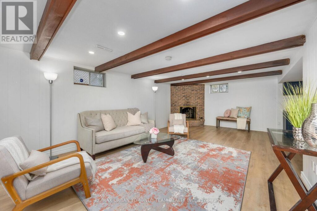 Cozy wood-paneled living room with cream velvet accents and a fireplace focal point.